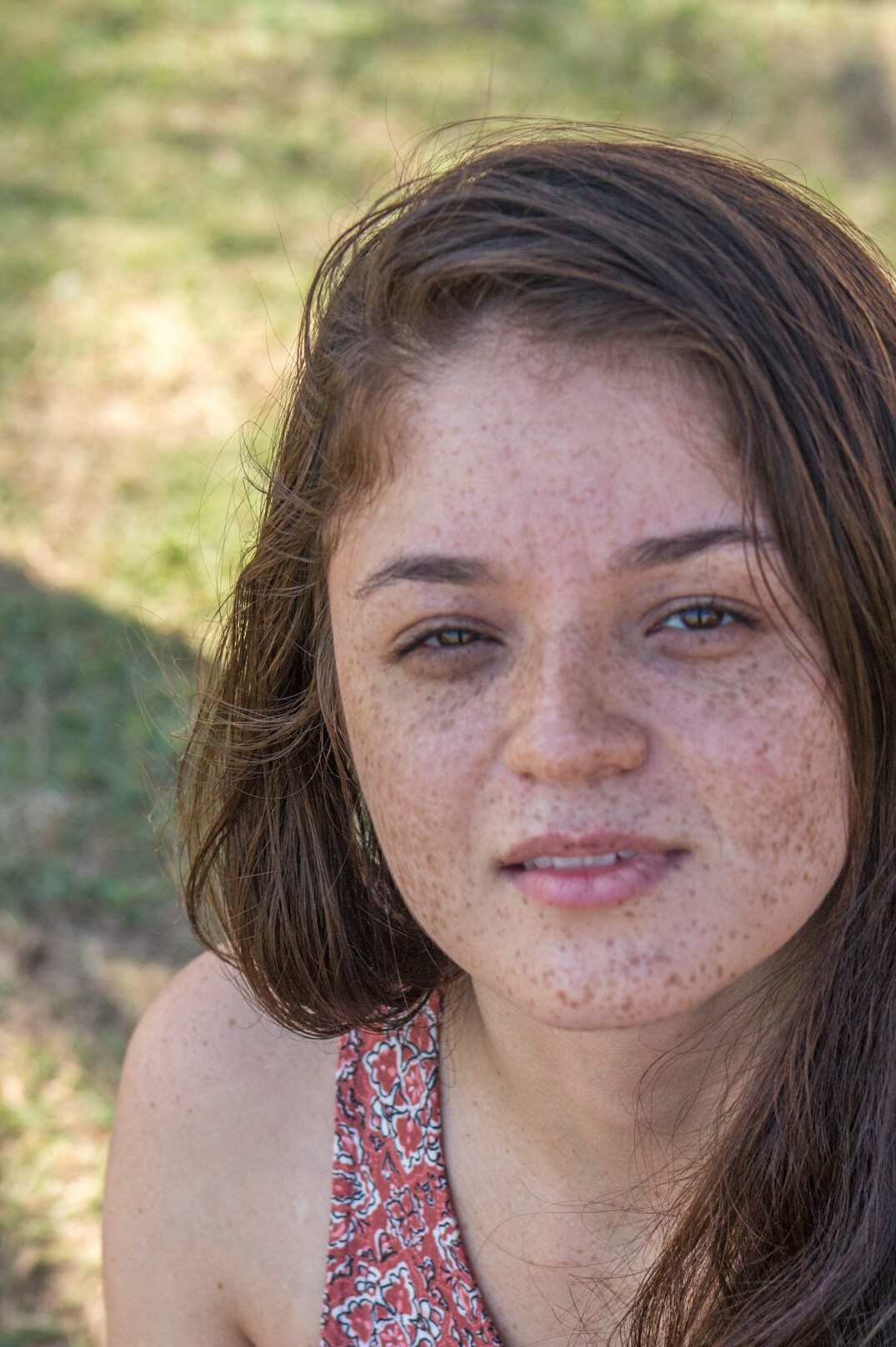 Portrait of a young woman with brown hair smiling